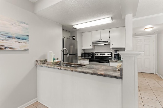 kitchen with sink, light tile patterned floors, a textured ceiling, white cabinets, and appliances with stainless steel finishes