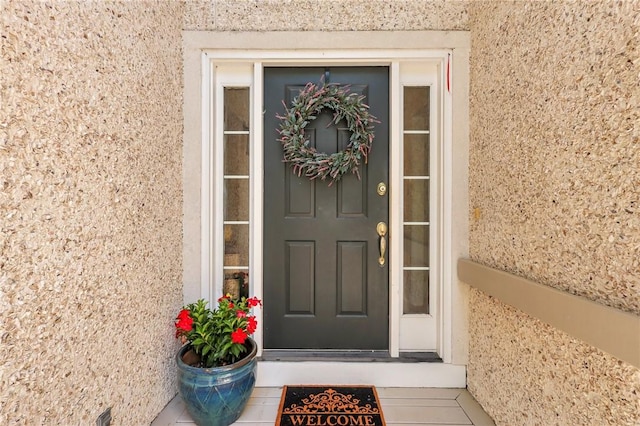 entrance to property with stucco siding