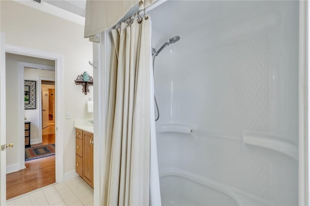 full bath featuring vanity, baseboards, and tile patterned floors