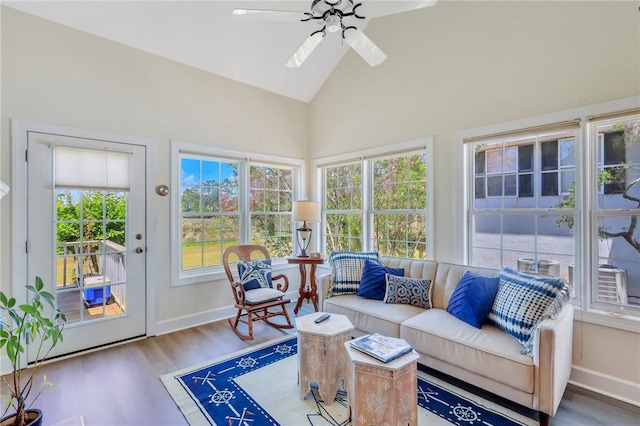 sunroom with a ceiling fan and lofted ceiling