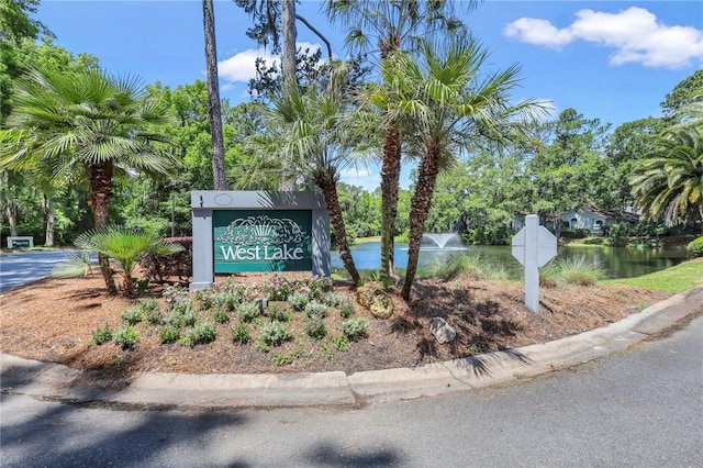 community / neighborhood sign with a water view