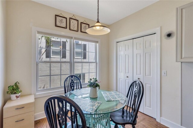 dining area with baseboards and light wood-style floors