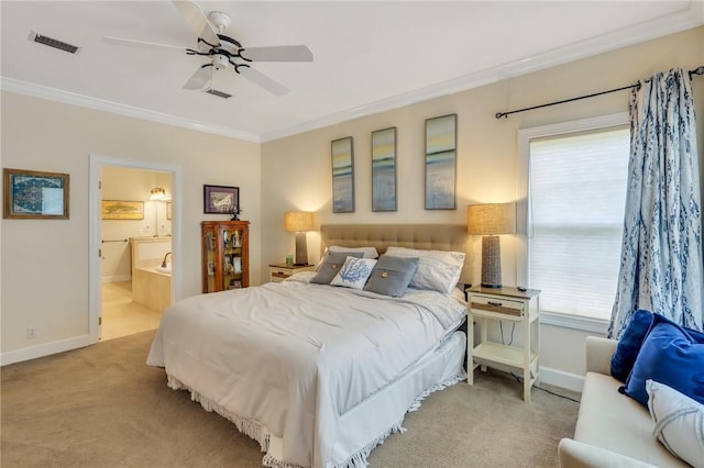 carpeted bedroom featuring baseboards, ensuite bath, visible vents, and crown molding