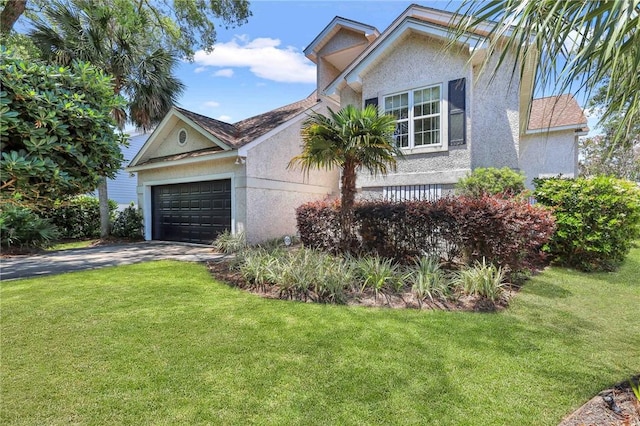 view of front facade with a garage and a front lawn