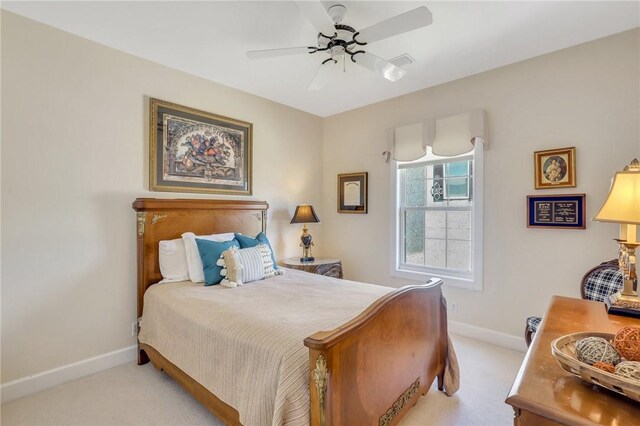 bedroom featuring baseboards, a ceiling fan, and light colored carpet