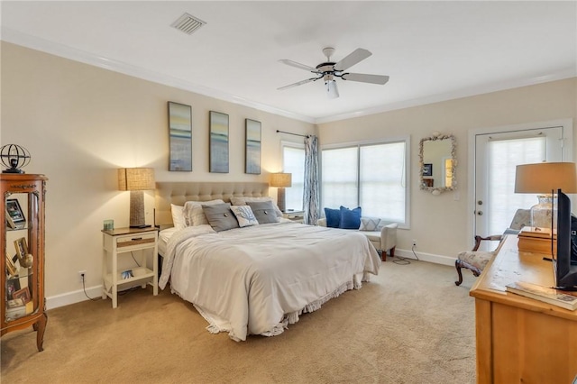 bedroom with baseboards, visible vents, light colored carpet, ceiling fan, and ornamental molding