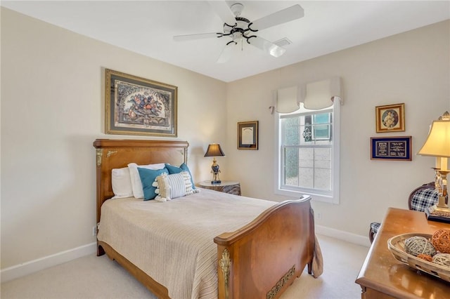 bedroom featuring light carpet, ceiling fan, and baseboards