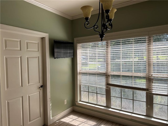 116 Bartram Trl, Blackshear, GA 31516 - unfurnished dining area with a chandelier, healthy amount of natural light, baseboards, and ornamental molding