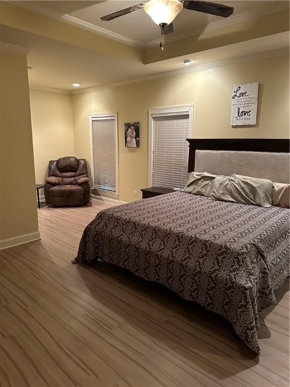 116 Bartram Trl, Blackshear, GA 31516 - bedroom with ornamental molding, wood finished floors, baseboards, a ceiling fan, and a tray ceiling