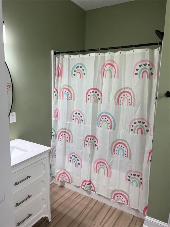 116 Bartram Trl, Blackshear, GA 31516 - bathroom with vanity, wood finished floors, and a shower with shower curtain