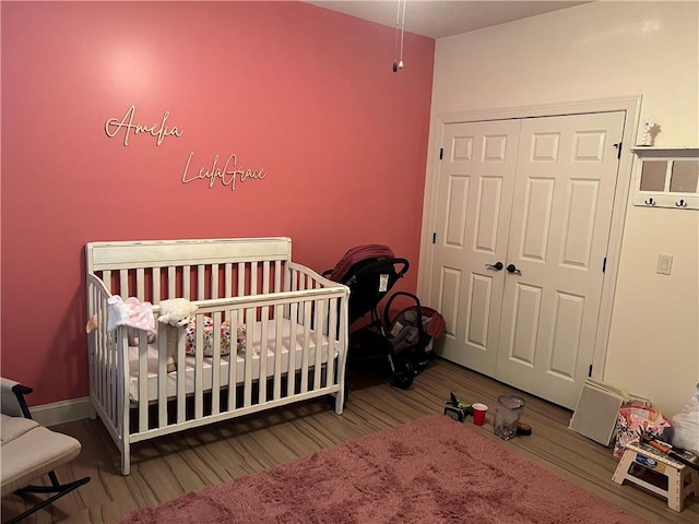 116 Bartram Trl, Blackshear, GA 31516 - bedroom with wood finished floors, a closet, a nursery area, and baseboards