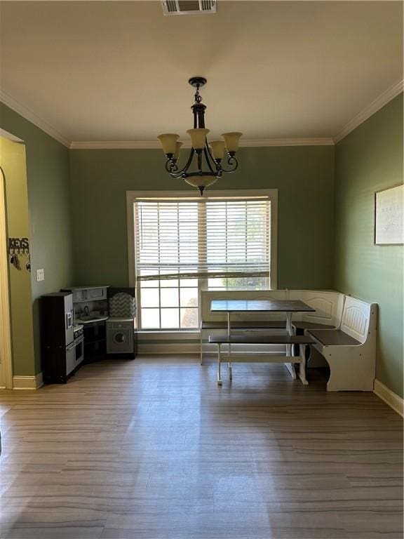116 Bartram Trl, Blackshear, GA 31516 - dining room with a chandelier, light wood-style floors, ornamental molding, and baseboards