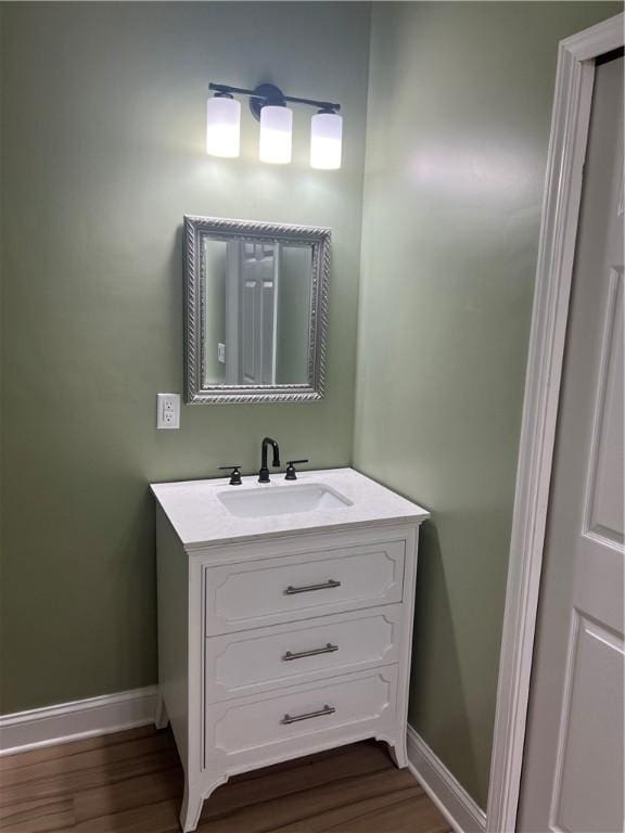 116 Bartram Trl, Blackshear, GA 31516 - bathroom with vanity, baseboards, and wood finished floors