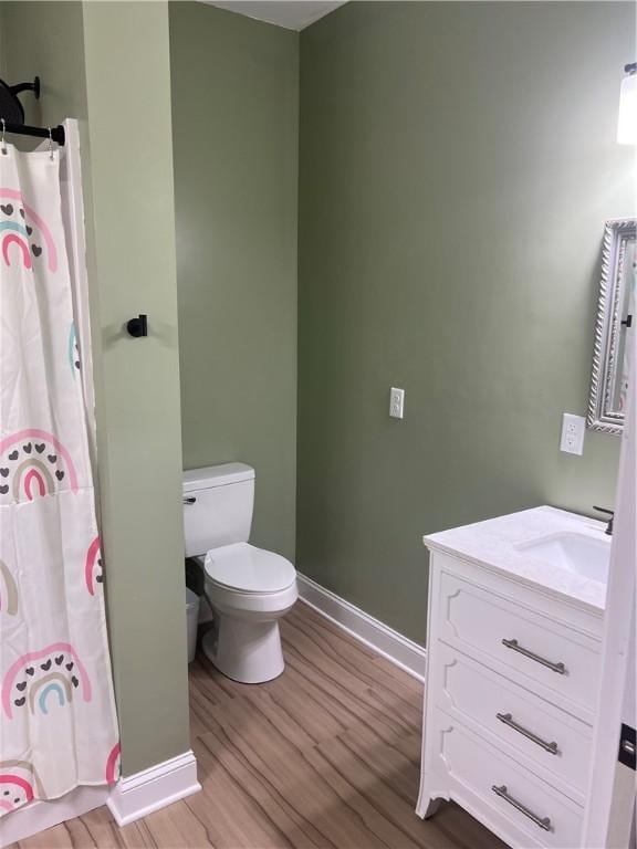 116 Bartram Trl, Blackshear, GA 31516 - full bathroom with wood finished floors, vanity, baseboards, and toilet