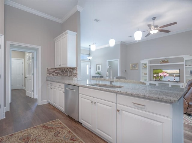 kitchen featuring sink, dark hardwood / wood-style floors, white cabinets, stainless steel dishwasher, and kitchen peninsula