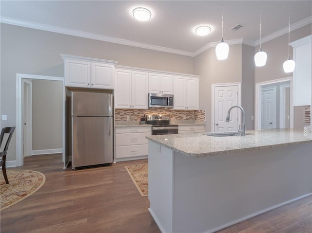 kitchen with sink, white cabinetry, stainless steel appliances, light stone counters, and decorative light fixtures