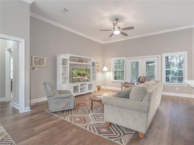 living room featuring ornamental molding, dark hardwood / wood-style floors, a healthy amount of sunlight, and french doors