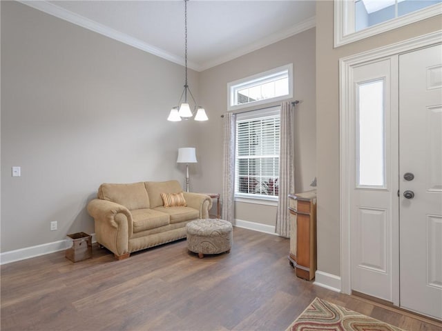 living room with ornamental molding, dark wood-type flooring, and a chandelier