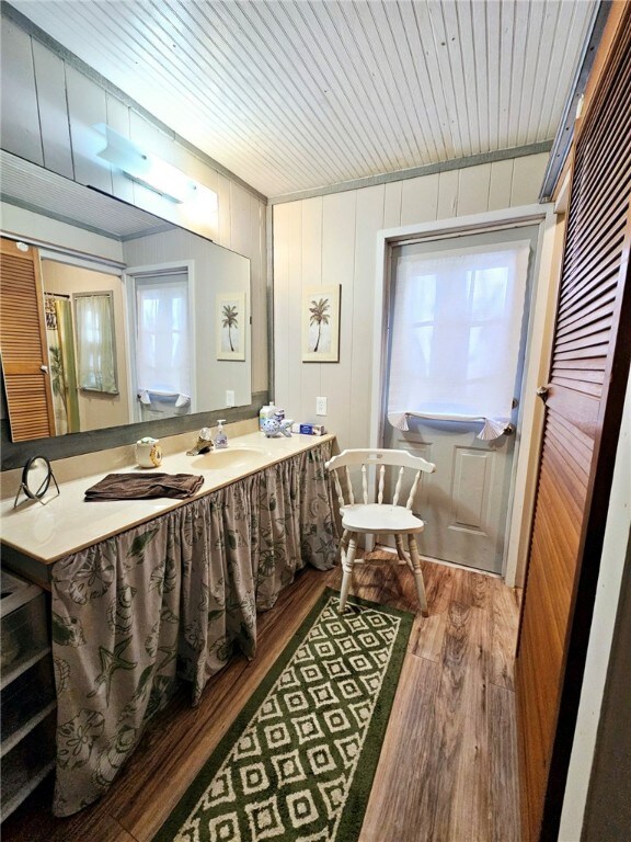 bathroom featuring a wealth of natural light, vanity, wood ceiling, and hardwood / wood-style flooring