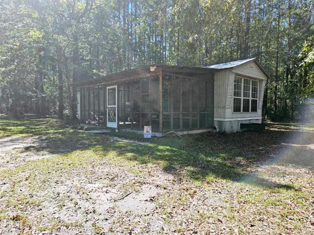 view of outbuilding with a sunroom