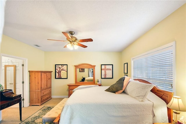 bedroom featuring light carpet and ceiling fan