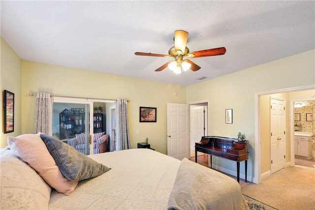 carpeted bedroom with connected bathroom and ceiling fan