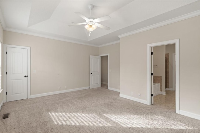 1407 Reserve Ct, Saint Simons Island, GA 31522 - unfurnished bedroom featuring a raised ceiling, ornamental molding, light colored carpet, and ensuite bath