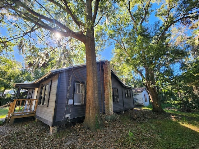 view of side of property with a wooden deck