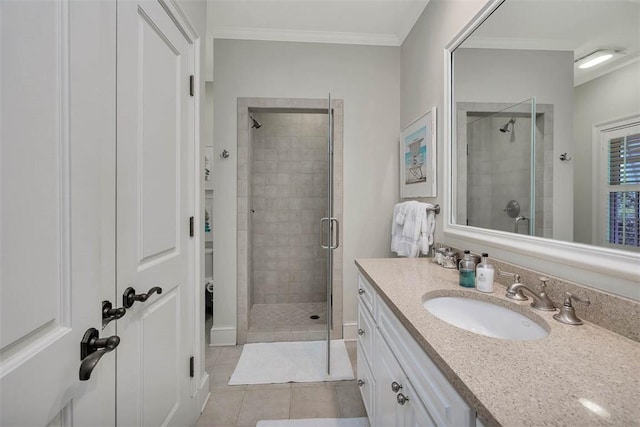 bathroom with ornamental molding, a shower stall, vanity, and tile patterned floors