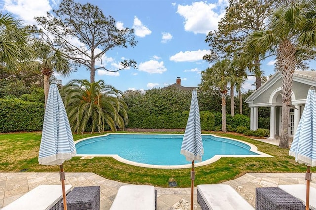 outdoor pool with a patio area