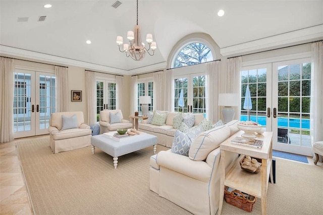 sunroom featuring vaulted ceiling, french doors, and visible vents