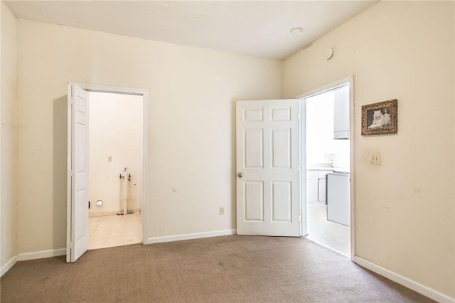 1006 Roosevelt St, Waycross, GA 31503 - unfurnished bedroom featuring carpet floors, connected bathroom, and baseboards