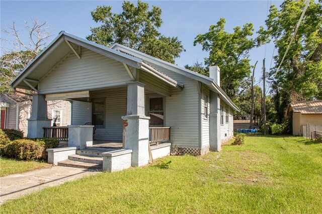 1006 Roosevelt St, Waycross, GA 31503 - view of front of property featuring a porch, a front yard, and a chimney