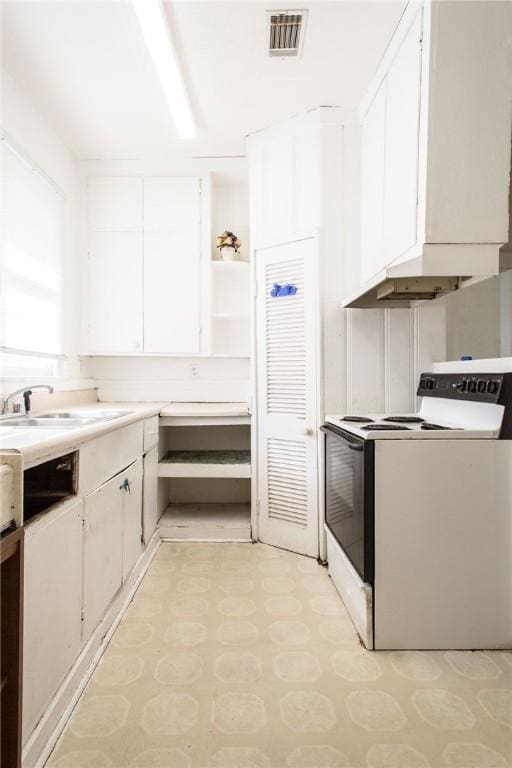 1006 Roosevelt St, Waycross, GA 31503 - kitchen featuring white electric stove, white cabinetry, light countertops, open shelves, and a sink