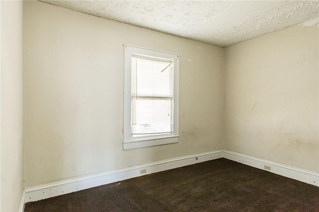 1006 Roosevelt St, Waycross, GA 31503 - unfurnished room featuring dark colored carpet, baseboards, and a textured ceiling