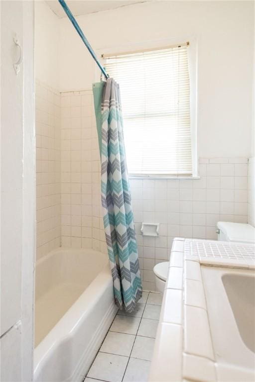 1006 Roosevelt St, Waycross, GA 31503 - full bathroom with toilet, tile patterned flooring, tile walls, shower / tub combo, and a sink