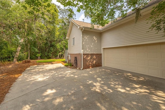 189 Harbor Pointe Dr, Brunswick, GA 31523 - view of side of property with concrete driveway and brick siding
