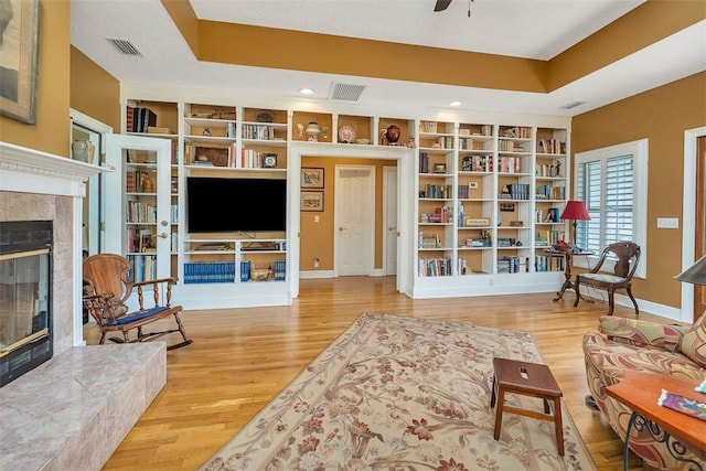 189 Harbor Pointe Dr, Brunswick, GA 31523 - living room with a high end fireplace, wood finished floors, a ceiling fan, built in shelves, and recessed lighting