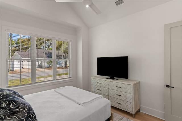 bedroom with hardwood / wood-style flooring, ceiling fan, and lofted ceiling