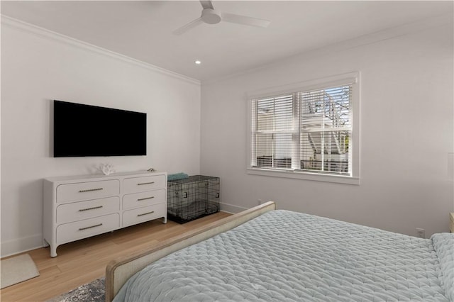 bedroom with ceiling fan, light hardwood / wood-style floors, and ornamental molding