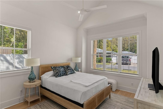 bedroom with light hardwood / wood-style flooring, ceiling fan, and lofted ceiling