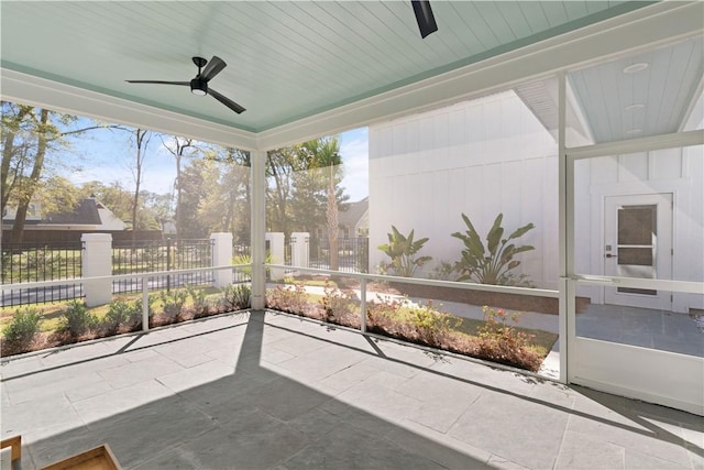 sunroom featuring ceiling fan