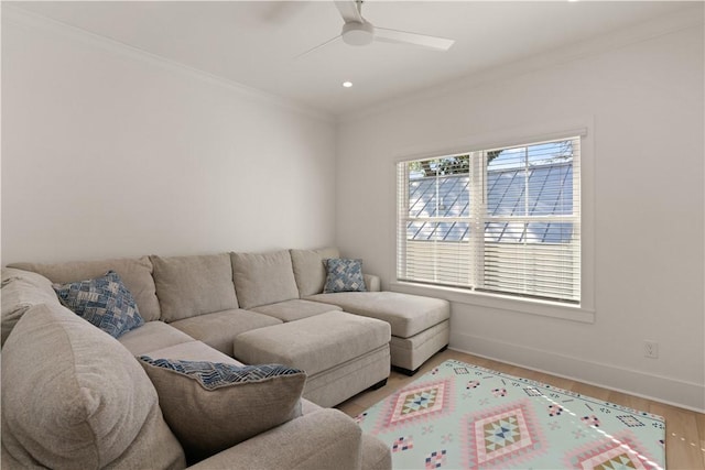 living room featuring light hardwood / wood-style flooring, ceiling fan, and ornamental molding