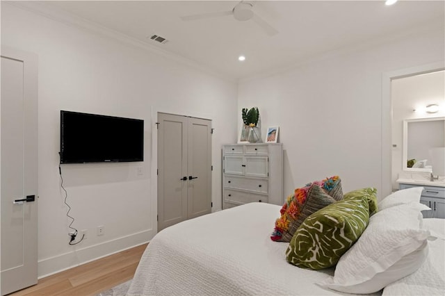 bedroom featuring connected bathroom, ceiling fan, crown molding, and light hardwood / wood-style floors