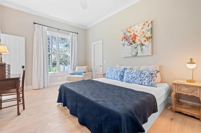 bedroom with hardwood / wood-style floors, ceiling fan, and crown molding