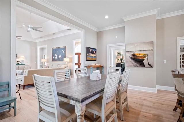 dining space featuring crown molding, light hardwood / wood-style flooring, and ceiling fan