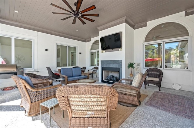 view of patio / terrace with an outdoor living space with a fireplace and ceiling fan