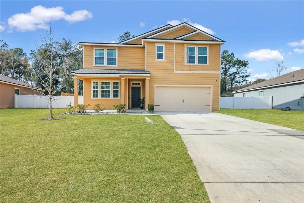 view of front of house with a garage and a front lawn