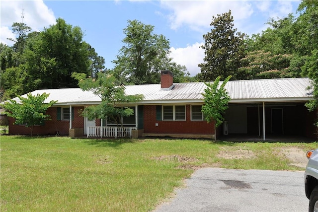 695 Lanes Bridge Rd, Jesup, GA 31545 - ranch-style home featuring a front yard, a carport, a chimney, and metal roof