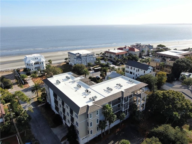 birds eye view of property with a water view and a view of the beach